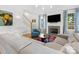 Bright living room features a fireplace with wall-mounted TV and adjacent staircase at 1614 Brook Rd, Charlotte, NC 28205
