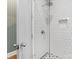 A clean and modern shower featuring white subway tiles, a glass door and sleek fixtures at 1614 Brook Rd, Charlotte, NC 28205