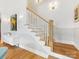Staircase with hardwood steps, painted risers, and wainscoting at 1614 Brook Rd, Charlotte, NC 28205