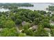 Picturesque aerial view of a lakeside home surrounded by lush trees and a serene lake, offers privacy at 21305 Sandy Cove Rd, Cornelius, NC 28031