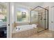 Bathroom features a jacuzzi tub and glass shower at 21305 Sandy Cove Rd, Cornelius, NC 28031
