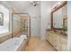 Bathroom with a soaking tub, glass shower, and granite countertops at 21305 Sandy Cove Rd, Cornelius, NC 28031