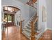 Elegant foyer with staircase, hardwood floors, and view of the front door, offering a warm welcome at 21305 Sandy Cove Rd, Cornelius, NC 28031