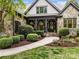 Charming home with a covered front porch and beautifully landscaped walkway leading to the entrance at 21305 Sandy Cove Rd, Cornelius, NC 28031
