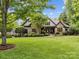Charming home with stone facade, manicured landscaping, and a welcoming front porch, exudes curb appeal at 21305 Sandy Cove Rd, Cornelius, NC 28031