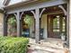 Inviting front porch with rocking chairs and decorative plants offering a relaxing outdoor space at 21305 Sandy Cove Rd, Cornelius, NC 28031