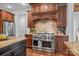 Gourmet kitchen boasts stainless steel appliances, a large island, and custom cabinetry at 21305 Sandy Cove Rd, Cornelius, NC 28031