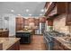 Chef's kitchen with professional-grade stainless steel appliances and custom wood cabinetry at 21305 Sandy Cove Rd, Cornelius, NC 28031