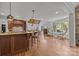 Open kitchen with a large island, wood floors, and an adjacent dining area at 21305 Sandy Cove Rd, Cornelius, NC 28031