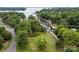 Prime lake lot with boat ramp and dock access, offering endless opportunities for water activities and scenic views at 21305 Sandy Cove Rd, Cornelius, NC 28031