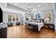 Bright main bedroom boasts hardwood floors, tray ceiling, and lots of natural light at 21305 Sandy Cove Rd, Cornelius, NC 28031