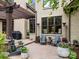 Outdoor patio with a stone surround, comfortable seating, and a grill for entertaining at 21305 Sandy Cove Rd, Cornelius, NC 28031