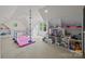 Bright playroom with gymnastics equipment, built-in shelving, and natural light from multiple windows at 21305 Sandy Cove Rd, Cornelius, NC 28031