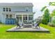 Large outdoor space featuring a fire pit, seating area, and a view of the home's exterior at 2164 Hanging Rock Rd, Fort Mill, SC 29715