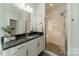 Bathroom showcasing a glass shower with a decorative tile surround and a granite-topped vanity at 2164 Hanging Rock Rd, Fort Mill, SC 29715