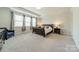 This spacious bedroom features large windows, a tray ceiling and neutral decor at 2164 Hanging Rock Rd, Fort Mill, SC 29715