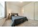 Calm bedroom with a bed, side table, and natural light from the window at 2164 Hanging Rock Rd, Fort Mill, SC 29715