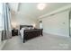 A bright bedroom has soft carpeting, tray ceilings, and neutral decor at 2164 Hanging Rock Rd, Fort Mill, SC 29715