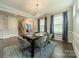 Bright dining room with modern chandelier, table setting, and large windows with natural light at 2164 Hanging Rock Rd, Fort Mill, SC 29715