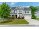 Charming two-story home features a manicured lawn and an attached two-car garage at 2164 Hanging Rock Rd, Fort Mill, SC 29715
