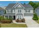 Charming two-story home features a manicured lawn and an attached two-car garage at 2164 Hanging Rock Rd, Fort Mill, SC 29715