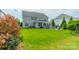 Large backyard with a patio, grilling area, and green space surrounded by neighboring homes at 2164 Hanging Rock Rd, Fort Mill, SC 29715