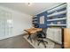 Stylish home office with a wood desk, floating shelves, and ample natural light at 2164 Hanging Rock Rd, Fort Mill, SC 29715