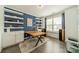 Stylish home office with a wood desk, floating shelves, and ample natural light at 2164 Hanging Rock Rd, Fort Mill, SC 29715