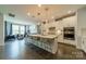 A kitchen with a large island and seating opens to the living room in an open-concept design at 2164 Hanging Rock Rd, Fort Mill, SC 29715