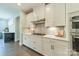 A kitchen features white cabinets, stainless steel appliances, and a gas cooktop at 2164 Hanging Rock Rd, Fort Mill, SC 29715