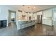 Modern kitchen with an island, pendant lighting, stainless steel appliances, and hardwood floors at 2164 Hanging Rock Rd, Fort Mill, SC 29715