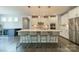 Modern kitchen with an island, pendant lighting, stainless steel appliances, and hardwood floors at 2164 Hanging Rock Rd, Fort Mill, SC 29715