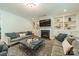 A living room with fireplace, built-in shelves, and plenty of seating at 2164 Hanging Rock Rd, Fort Mill, SC 29715