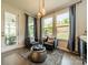 A sunroom features two chairs, many windows, and view of backyard at 2164 Hanging Rock Rd, Fort Mill, SC 29715