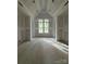 Spacious bedroom with a vaulted ceiling and large window, ready for drywall and finishes at 3030 Brookridge Ln, Charlotte, NC 28211