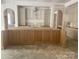 Spacious kitchen island with ample counter space and cabinets ready for finishing touches at 3030 Brookridge Ln, Charlotte, NC 28211
