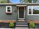 Stylish front entrance featuring a decorative wreath, a covered awning, and manicured bushes on stone steps at 322 Corriher Heights Ave, China Grove, NC 28023