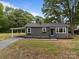 Single story home with a covered carport, tidy landscaping, and neutral color scheme at 322 Corriher Heights Ave, China Grove, NC 28023