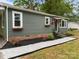 Close-up of front yard, showing the tidy landscaping, flowers and brick foundation at 322 Corriher Heights Ave, China Grove, NC 28023
