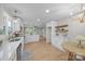 Open-concept kitchen with stainless appliances, white cabinetry, modern lighting, and hardwood floors at 322 Corriher Heights Ave, China Grove, NC 28023