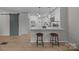 Bright kitchen featuring white cabinets, modern appliances, breakfast bar with seating, and barn door detail at 322 Corriher Heights Ave, China Grove, NC 28023