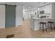 Modern kitchen and entry featuring white cabinets, stainless steel appliances and breakfast bar seating at 322 Corriher Heights Ave, China Grove, NC 28023