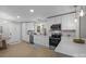Updated kitchen features white cabinetry, stainless appliances, and ample counter space with a seamless flow at 322 Corriher Heights Ave, China Grove, NC 28023