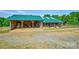 Rustic barn featuring open storage, a green metal roof, and a picturesque rural setting at 3400 Baucom Manor Rd, Monroe, NC 28110