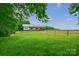 Charming white barn with a green roof and horse paddocks, set in a lush green pasture at 3400 Baucom Manor Rd, Monroe, NC 28110