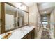 Elegant bathroom with a large mirror, decorative wallpaper, and updated fixtures at 3400 Baucom Manor Rd, Monroe, NC 28110