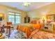 Cozy bedroom with a floral rug, stylish furniture, warm colors and plenty of natural light at 3400 Baucom Manor Rd, Monroe, NC 28110