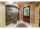Inviting entryway featuring a decorative mural, stone fountain, and a rustic wooden door at 3400 Baucom Manor Rd, Monroe, NC 28110
