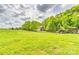 Beautiful home nestled on a spacious green lot with fencing, a covered carport, and ample parking at 3400 Baucom Manor Rd, Monroe, NC 28110
