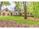 Charming home with stone and siding exterior, surrounded by a well-manicured lawn and mature trees at 3400 Baucom Manor Rd, Monroe, NC 28110